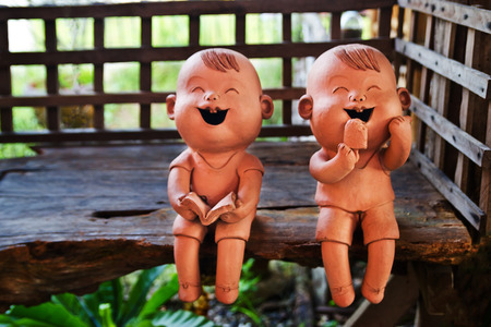 two statuettes of funny boy and girlの写真素材