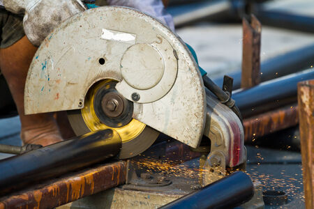 cutting steel with machine for cutting steel by workerの写真素材