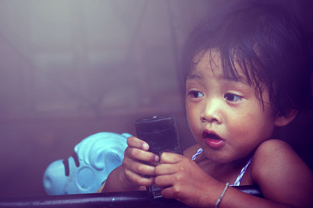 Happy baby girl talking on mobile phone isolated on white. Closeupの写真素材
