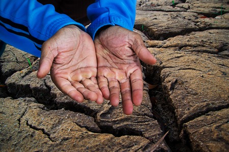 Beggar people and human poverty concept - senior person hands begging for food or helpの写真素材