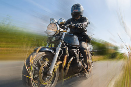 Biker on the road against the skyの写真素材