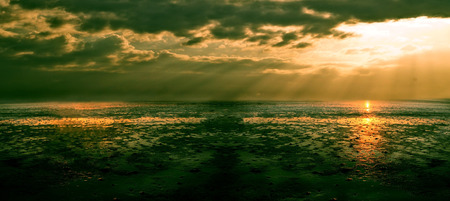 piece of desert land against the sea and sunset. Vintage styleの写真素材