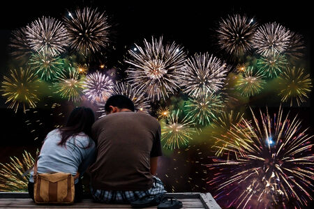 Couple in the sunset time sitting at wooden bridge on the way to the harbor in Sunset time at Mak island, thailandの写真素材