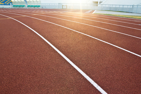 White lines and texture of running racetrack, red rubber racetracks in outdoor stadiumの写真素材