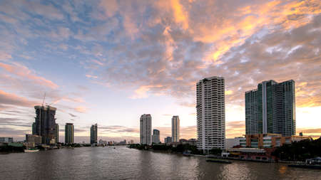 Beautiful sunset Chao Phraya River of the Metropolitan Bangkok City downtown cityscape urban , Cityscape Bangkok city Thailandの写真素材