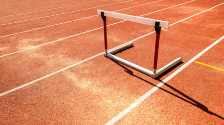 hurdle race barrier on red  running track , athletic stadiumの写真素材