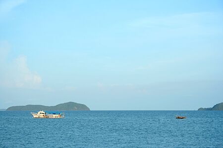 Small boats and big boats out to sea to fish from shore, Rawai Beach, Phuket Thailand