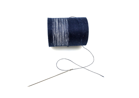 Spool of thread with needle isolated on white