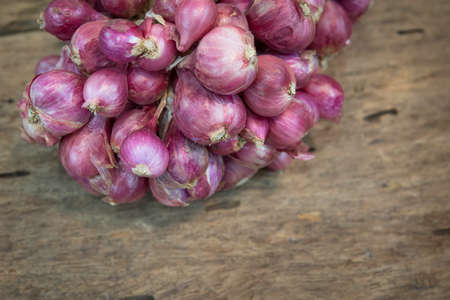 Shallot onions in a group on woodの写真素材