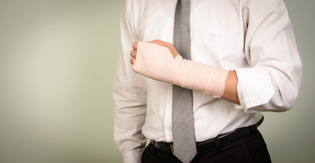 businessman with his broken left armの写真素材