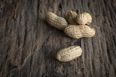 peanuts in shells on wood backgroundの写真素材