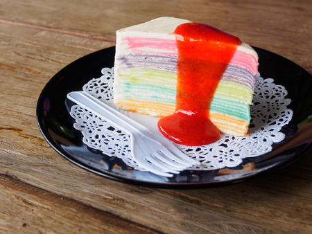 strawberry sauce on rainbow crape cakeの写真素材