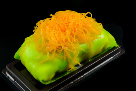 green cake rolls with foi thong on black backgroundの写真素材