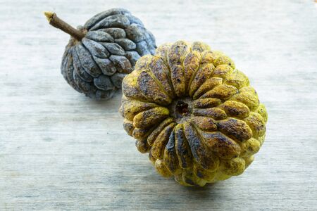 Close-up Ripe sugar apple (Annona squamosa) on wooden table background.の写真素材