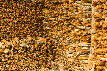 Background of dry chopped firewood logs in a pile の写真素材