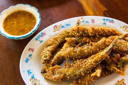Fried fish with spicy herb sauceの写真素材