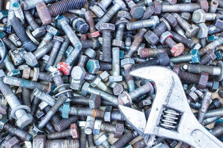 Spanner wrench and  screws on the wooden backgroundの写真素材