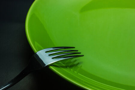 silver fork and spoon as utensils on plateの写真素材