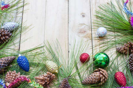 Pine cones hanging on a rope with wooden background.の写真素材