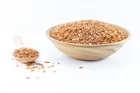 Sangyod brown GI rice on wooden spoon isolated on white background. Product of Thailand, Asia.の写真素材