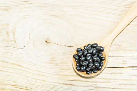 Black adzuki bean on wooden spoon. Product of Thailand, Asia.の写真素材