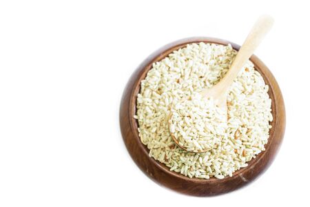 Brown rice on wooden spoon isolated on white  background. Product of Thailand, Asia.の写真素材
