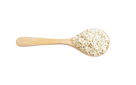 Brown rice on wooden spoon isolated on white  background. Product of Thailand, Asia.の写真素材