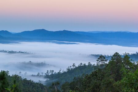 Layer of mountains in the mist at sunrise time, Wiang Haeng, Chiang Mai Province, Thailandの写真素材