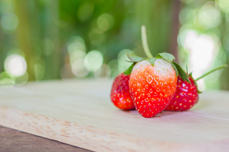 Fresh and ripe strawberries on a woodenの写真素材