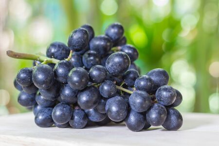 Black grapes on woodenの写真素材
