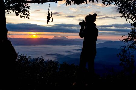 Photographer Camera Shooting Silhouette Outdoors Concept with tree frameの写真素材