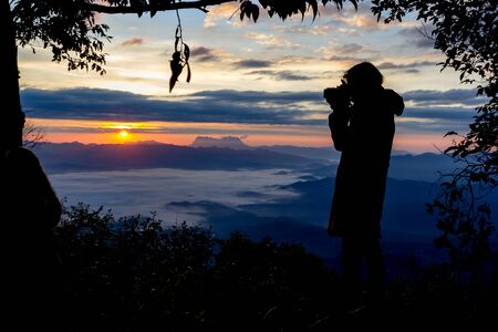 Photographer Camera Shooting Silhouette Outdoors Concept with tree frameの写真素材