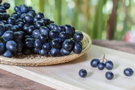 Black grapes on woodenの写真素材