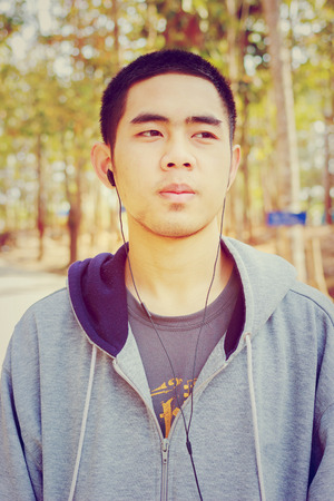 Portrait of Asia young teenage boy. Hand on chin.Vintage style.の写真素材