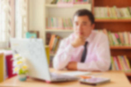 blurred office background , office worker at the computer, working dayの写真素材