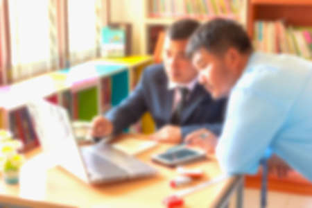 blurred office background , office worker at the computer, working dayの写真素材