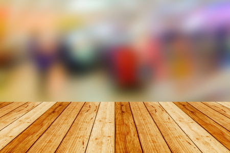 blurred image wood table and Abstract background of shopping mall, shallow depth of focus.の写真素材