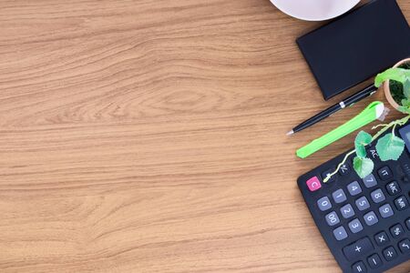 Office table with notepad and empty coffee cup. View from above with copy spaceの写真素材