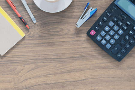 Office table with notepad and empty coffee cup. View from above with copy spaceの写真素材