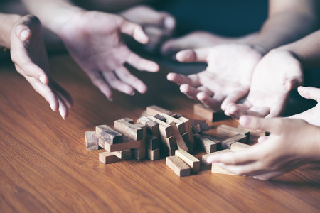 blocks wood game with word risk on tower wood block wooden table background. With copy space for...