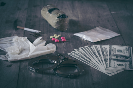 Hard drugs and alcohol on dark stone table. Top viewの写真素材