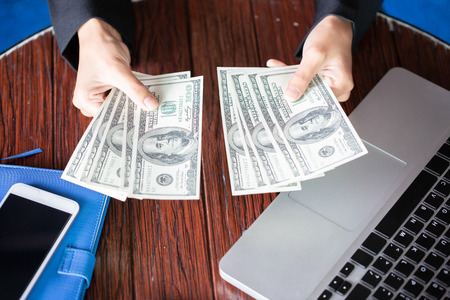 hand recount dollars. woman counts the money. new hundred-dollar bills