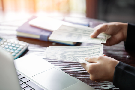 hand recount dollars. woman counts the money. new hundred-dollar billsの写真素材