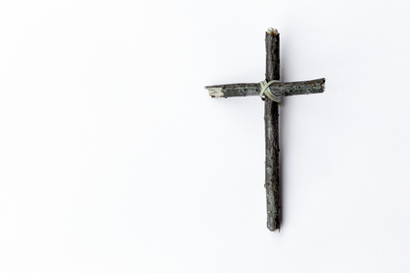 Cross made from tree branch isolated on white backgroundの写真素材