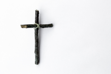 Cross made from tree branch isolated on white backgroundの写真素材