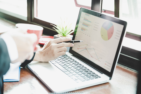 Business man working at office with laptop and documents on his deskの写真素材