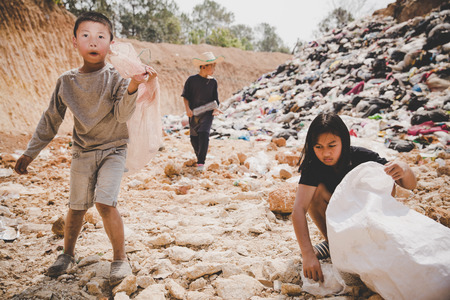 Poor children collect garbage for sale,, the concept of pollution and the environment,Recycling old rubbish,World Environment Dayの写真素材