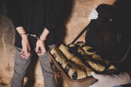 Law and police concept. Police arrest drug trafficker with handcuffs.の写真素材