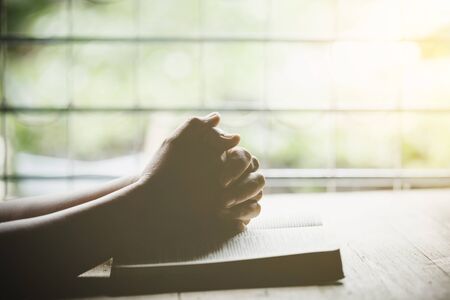 Closeup of christian senior woman praying to God at home in the morning.の写真素材