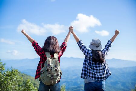 Travelers, young women, look at the amazing mountains and forests, wanderlust travel ideas, space...